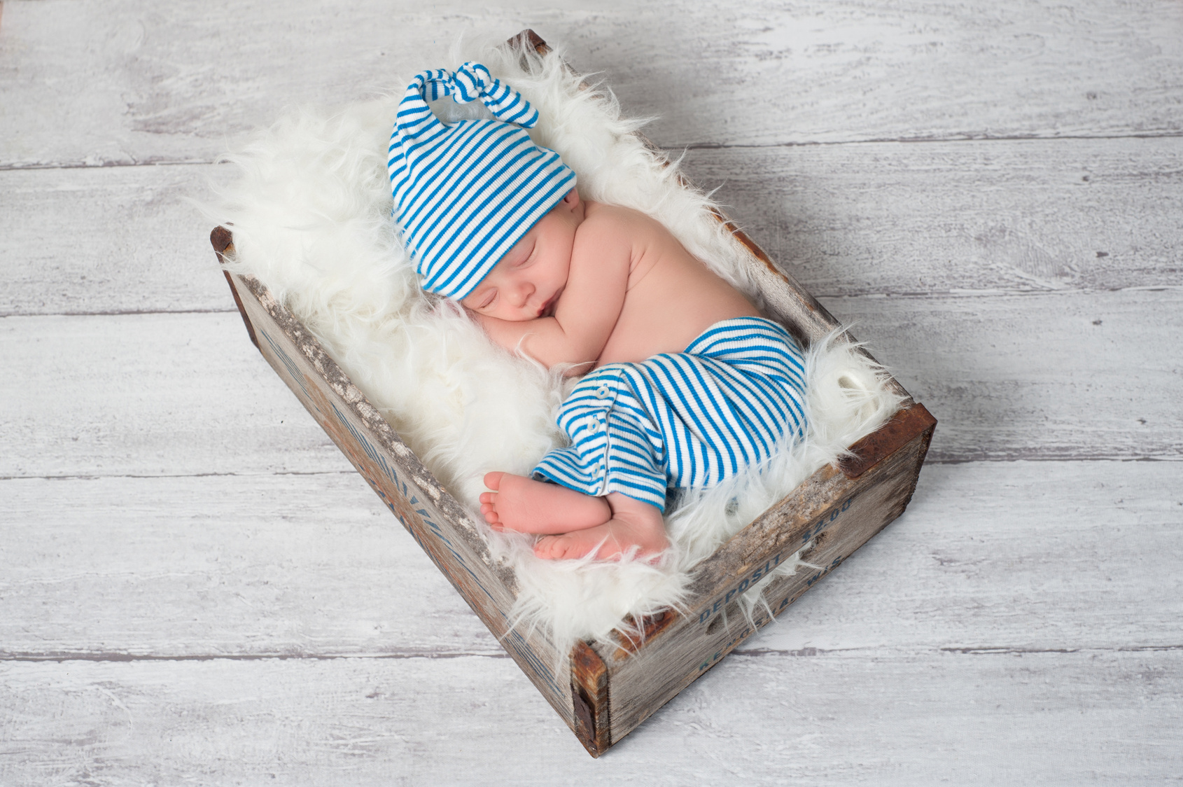 Sleeping Newborn Baby Wearing Pajamas and a Sleeping Cap